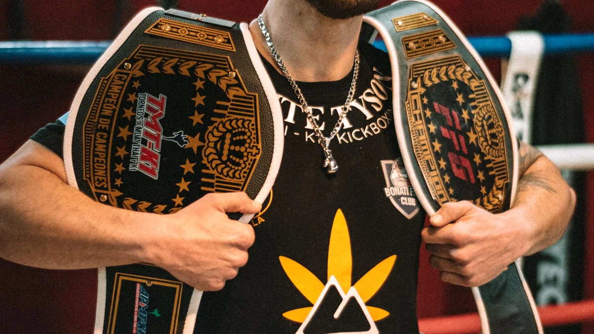 Illustrative boxing champion holding two title belts in a ring